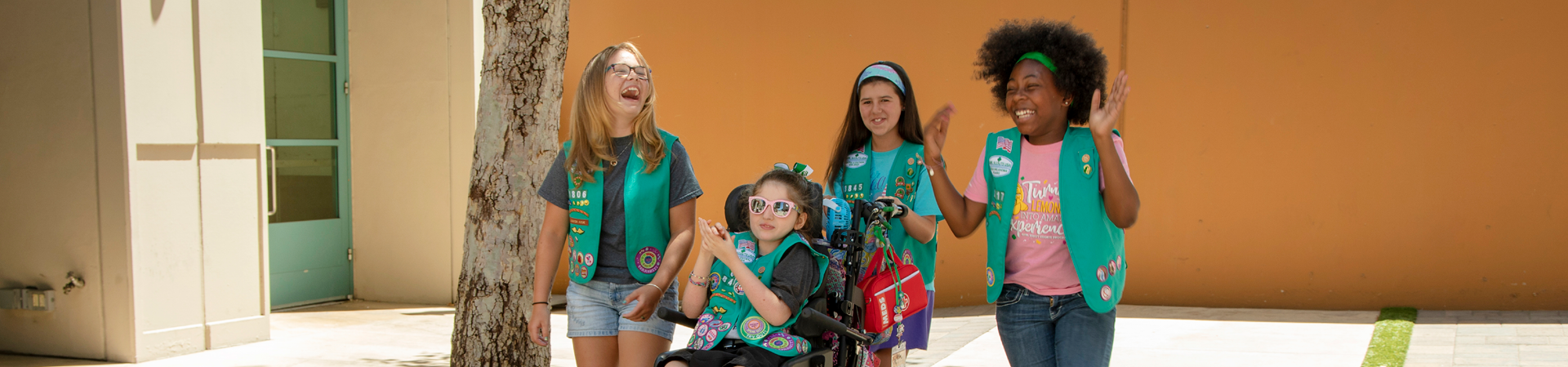  A group of Junior Girl Scouts laughing and smiling 